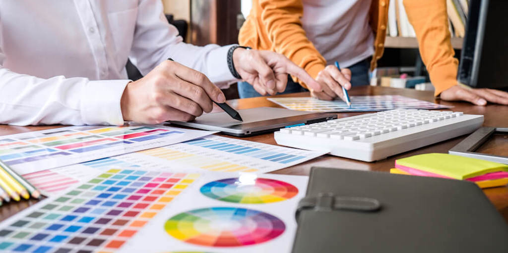 A wheel of colors and two coworkers making design decisions